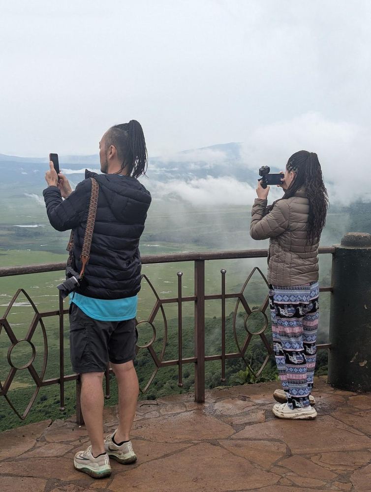 Travellers photographing the Ngorongoro Crater from a viewpoint