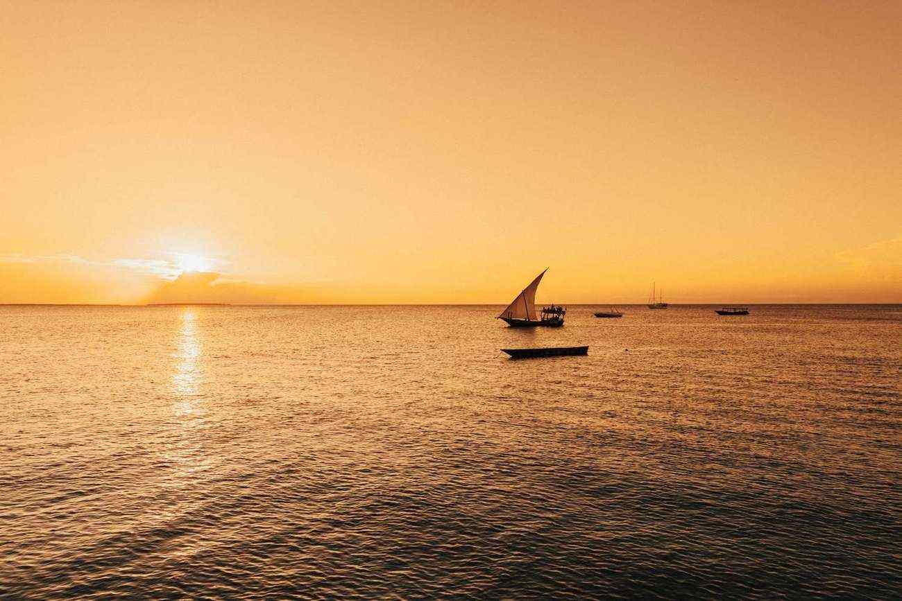 Traditional dhow sailing at golden hour off Zanzibar